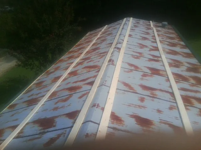 Rusted metal roof panels with new wood purlins before replacement — Storm Damage Roof Repair in Richton Park by Roofing Brothers
