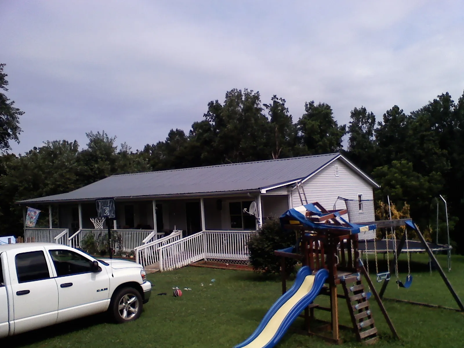 Dark metal roof on a country home with a full length front porch in Richton Park