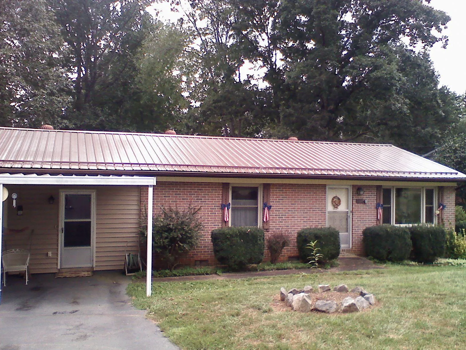 Bronze metal roof and carport on a brick ranch home — Roof Repair work by our crew in Richton Park