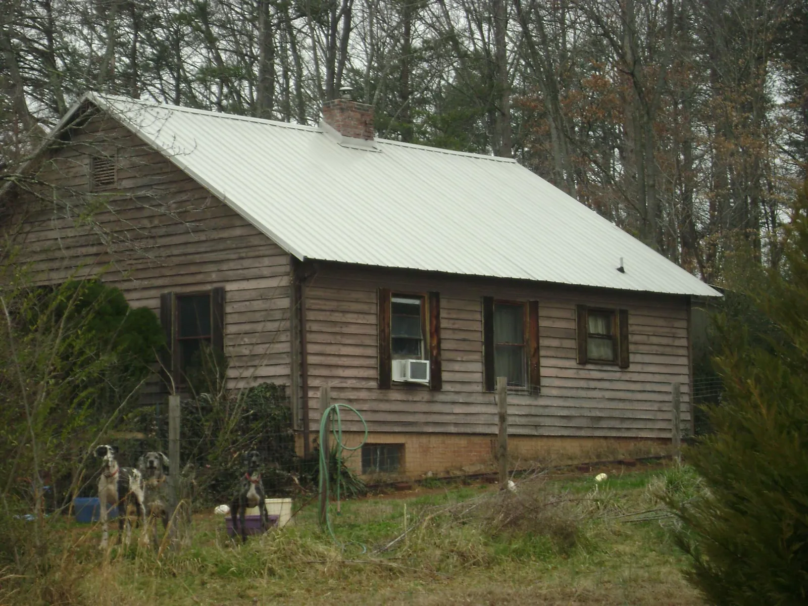 White metal roof on an old wood sided farmhouse, from a Metal Roof Installation job in Richton Park